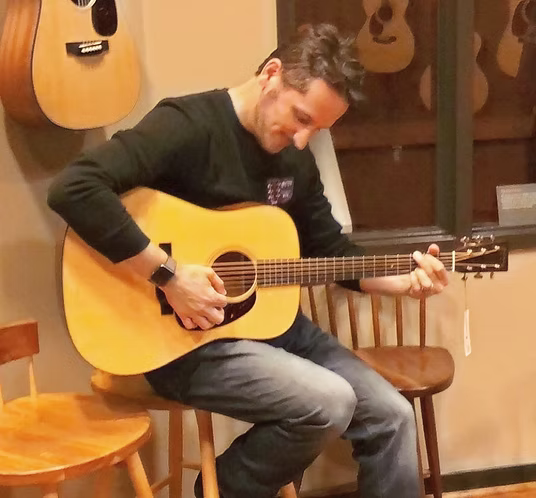 Adam King playing guitar